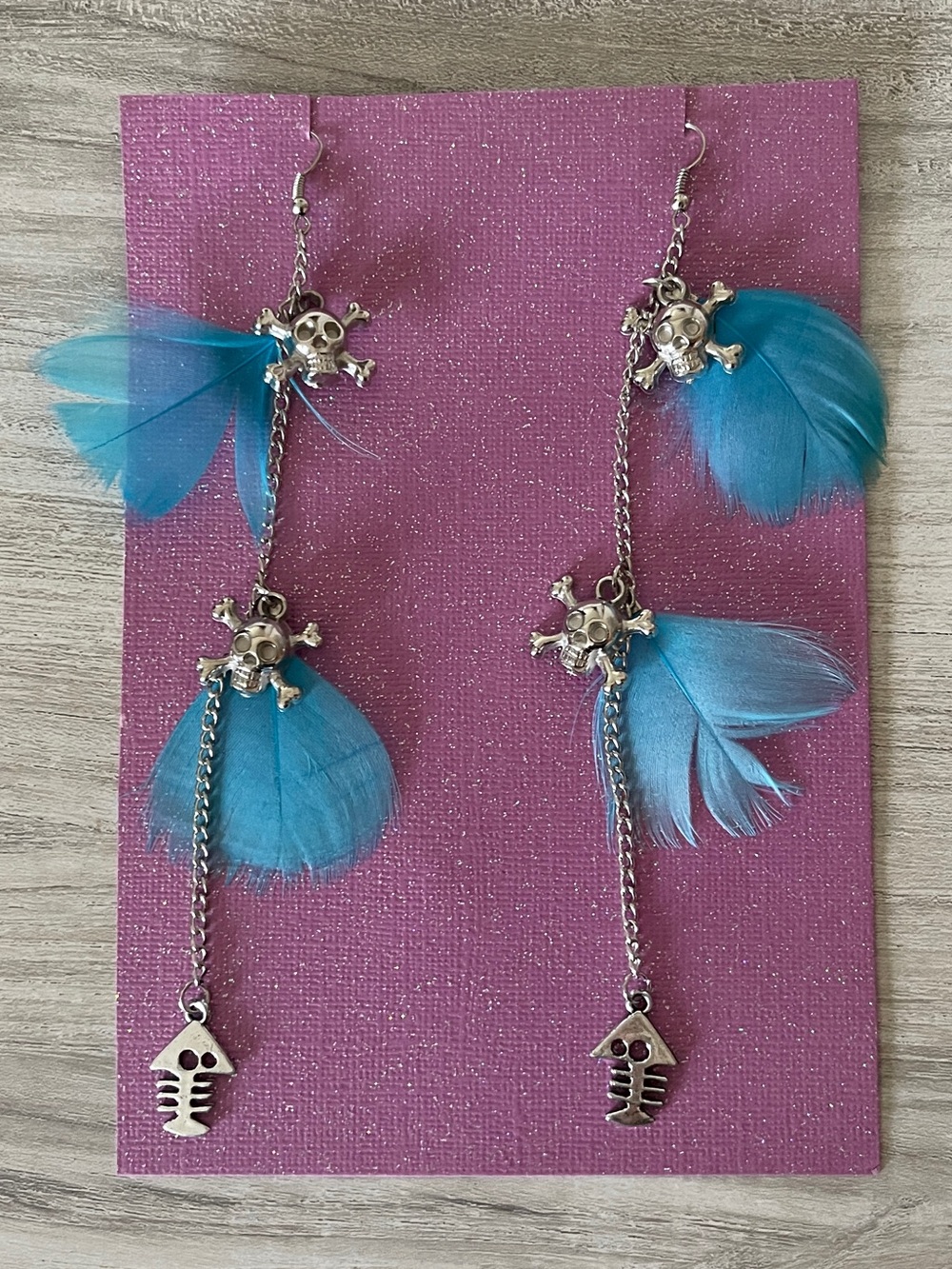Blue Feather Silver Crossbones Earrings 5.5”